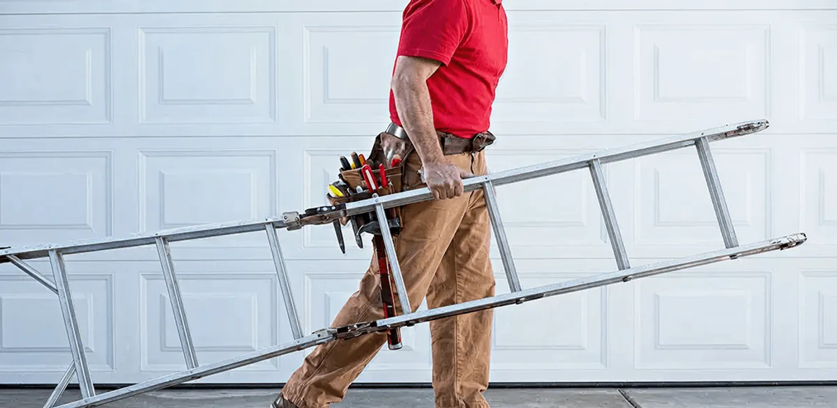 Garage door repair technician arriving with tools and ladder in Bellevue, WA