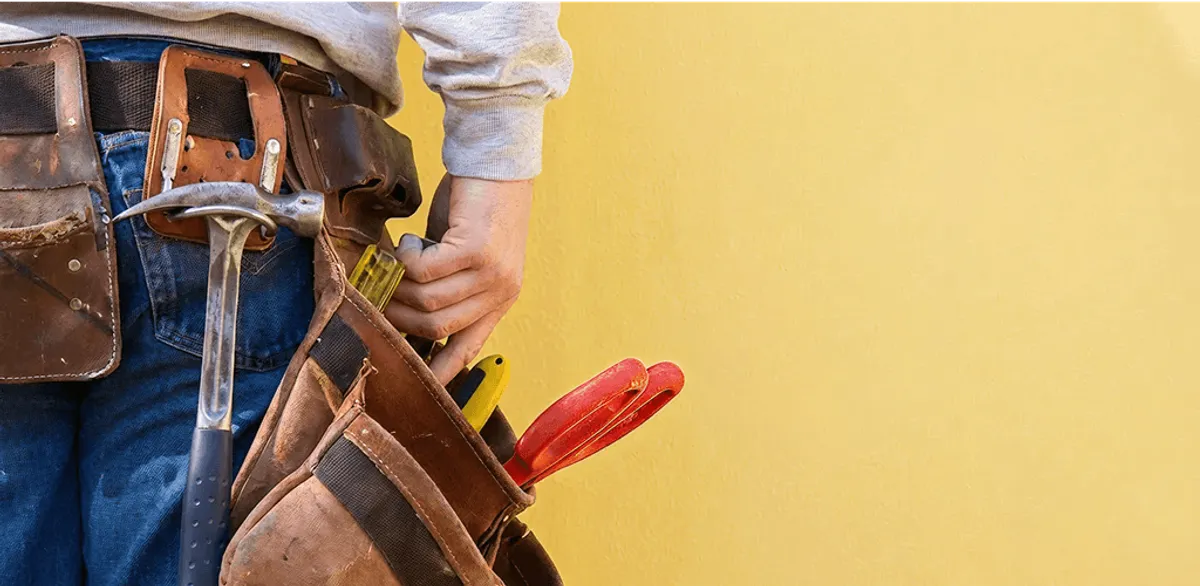 Handyman with tool belt ready for home repairs and maintenance in Bellevue, WA